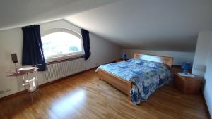 a bedroom with a bed and a large window at Villa Incanto in Forte dei Marmi