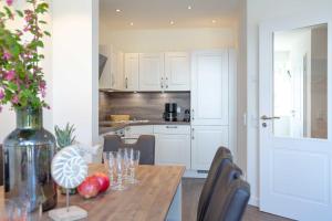 a kitchen with a wooden table with wine glasses on it at Haus Jensen 2 in List +21 photos