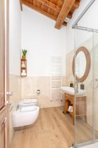 a bathroom with a white toilet and a sink at Agriturismo Ai Dossi in Verona