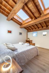 a bedroom with a large bed and wooden ceilings at Agriturismo Ai Dossi in Verona