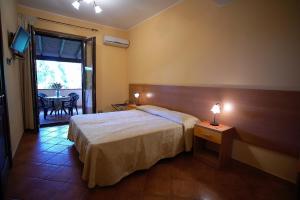 a hotel room with a bed and a table and a window at B&B Fort Apache in Monforte San Giorgio