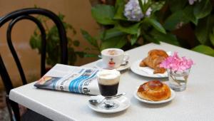 a table with two cups of coffee and pastries on it at B&B Fort Apache in Monforte San Giorgio