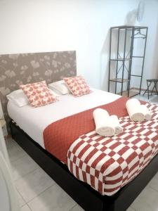 a bedroom with a large bed with red and white pillows at Madeirarooms in Funchal