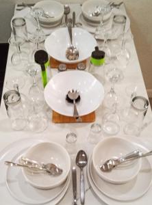 a table with white plates and glasses on it at Blue Waters in Cape Town