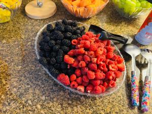 a bowl of berries and raspberries on a counter at Windcrest Inn and Suites in Fredericksburg