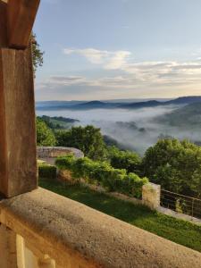 a view from a window of a foggy valley at Château de Termes in Martel