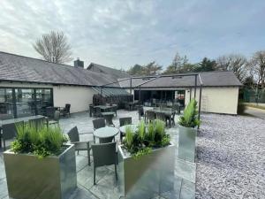 a patio at a restaurant with tables and chairs at Number 57 Brynteg in Caernarfon