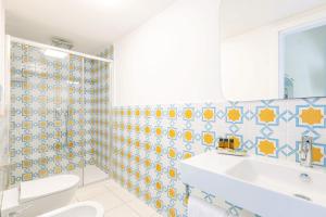 a bathroom with a toilet and a sink at YourHome - Adoro Positano in Positano +53 photos