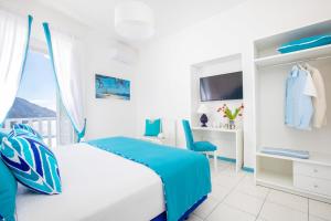 a white bedroom with a bed and a window at YourHome - Adoro Positano in Positano