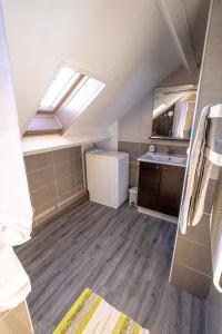 a small bathroom with a sink and a skylight at Coeur de Charente Maritime, la charentaise in Saint-Germain-de-Marencennes +2 photos