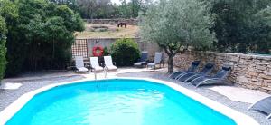 a swimming pool with a fountain in a yard at La Casa de los Arribes in Fornillos de Fermoselle