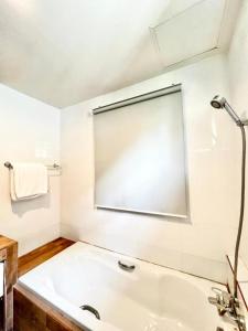 a white bathroom with a tub and a shower at Lay Back Villa C2 with Kitchen & High speed Internet in Krabi