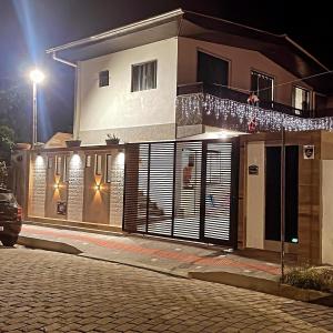 a house on a street at night at Sol-v-mar in Penha +10 photos