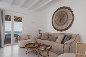 a living room with a couch and a table at Retreat Hill Luxury Villas Mykonos in Mýkonos City