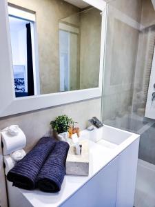 a bathroom with a sink and a mirror at Octagon Main Square Apartment in Zagreb