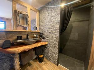a bathroom with a sink and a shower at Chambres du Gozzi in Afa