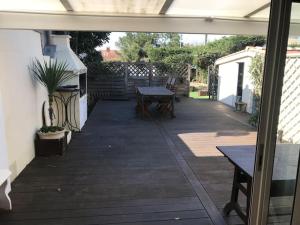 an outdoor patio with a table and a grill at MAMALO in Biscarrosse +3 photos