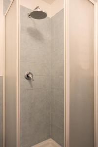 a bathroom with a shower with a glass door at Hola House alla Kalsa in Palermo
