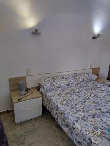 a small bedroom with a bed and a night stand at Cala Dorada in Salou