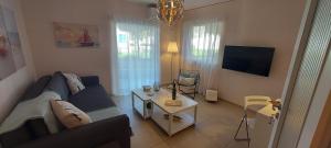 a living room with a couch and a table at OIKIKA I 6 in Artemida