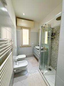 a bathroom with a shower and a toilet and a sink at ROOFTOP-MarinaCentro-Unique-Beach-Fun-Smart-LoveApt-Train-Park in Rimini