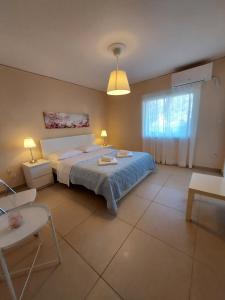 a bedroom with a bed and a table and chairs at OIKIKA I 6 in Artemida