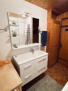 a bathroom with a white sink and a mirror at Très beau chalet familial - Vue superbe ! Plein sud in La Clusaz