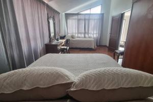 ein Hotelzimmer mit 2 Betten und einem Spiegel in der Unterkunft Central and quiet apartment in Cochabamba in Cochabamba