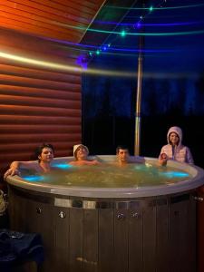 a group of people in a hot tub at Meiranu krasts in Bērzgale