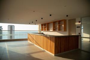a large kitchen with a large view of the ocean at Beachside Bliss: Salguero Suites in Gaira