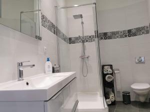 a bathroom with a shower and a sink and a toilet at Maison de village avec sa charmante grand chambre avec balcon in Fleury