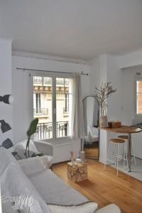 a living room with a couch and a table at Louis’ haven in Paris