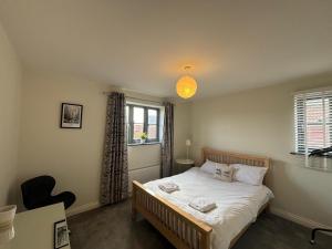 a small bedroom with a bed and a window at Rookery Cottage in Mundesley