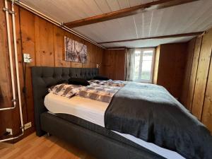 a large bed in a room with wooden walls at Apartment Deer in Grindelwald