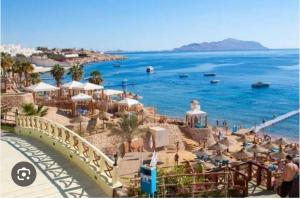a view of a beach with the ocean and a bridge at Naama bay apartment in Sharm El Sheikh