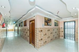 a hallway of a building with a brick wall at Super Capital O Hotel Bidisha in Digha