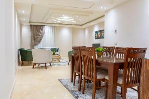 a dining room with a table and chairs at El Lotus Building in Cairo
