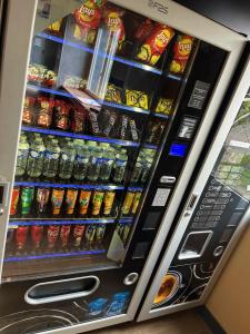 a vending machine filled with lots of drinks and soda at ibis budget Arles Sud Fourchon in Arles