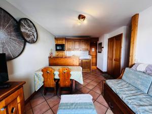 a kitchen with a table and chairs and a couch at Appartement Les Saisies, 3 pièces, 6 personnes - FR-1-293-224 in Les Saisies