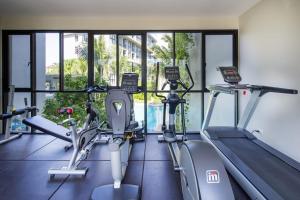 a gym with two treadmills and two ellipticals at 1 Bedroom Pool view at Diamond Resort in Bang Tao Beach +9 photos