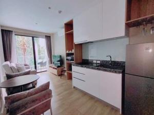 a kitchen with a counter and a table in a room at 1 Bedroom Pool view at Diamond Resort in Bang Tao Beach