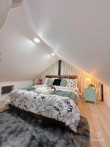 a bedroom with a large bed in a attic at Apple house cafe in Ban Rong Fong