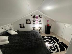 a bedroom with a large bed with a zebra blanket at Nordic Villa in Husum
