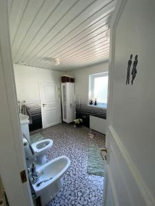 a bathroom with two sinks and two toilets at Nordic Villa in Husum