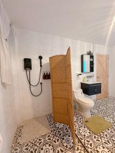 a bathroom with a toilet and a shower in it at Apple house cafe in Ban Rong Fong