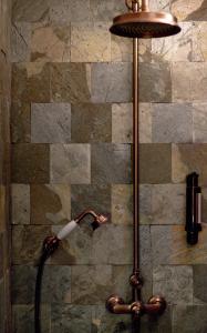 a floor lamp with a hose attached to a wall at CASADELLA - Casa Divina Citadelle in Bastia