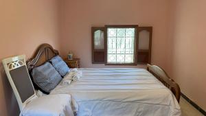 a large bed in a room with a window at Atlasunsea - Riad de l’Atlas in Imoulass