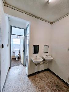 a bathroom with two sinks and a toilet at PANCHOR 6 HOSTEL in George Town