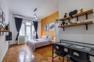 a bedroom with a bed and a desk in a room at Apartment Stay in Novi Sad