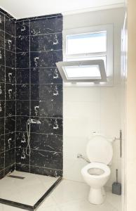 a bathroom with a toilet and a window at Karima House in Luxor